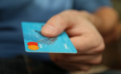 holding a credit card to make a payment