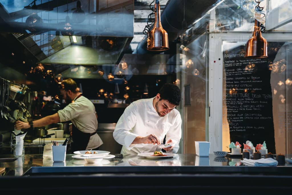 A chef preparing food in a restaurant kitchen