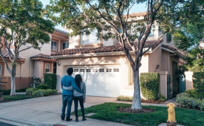 Couple Standing In Front of their House